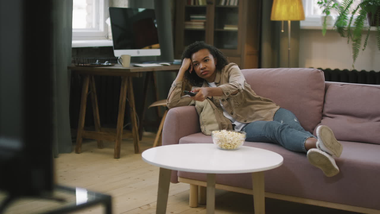 Afro Girl Switching Channels On TV