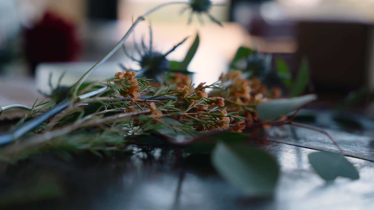 Close-up of floral wedding decorations on a rustic table, capturing the warm, natural wedding ambiance. Ideal for wedding themes and floral arrangements.