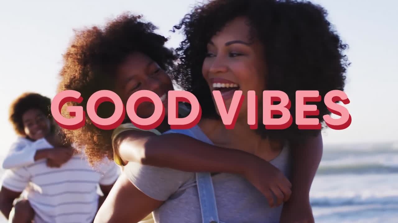 Animation of good vibes text over smiling african american family embracing at beach