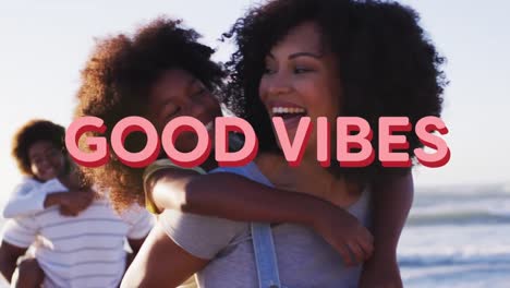 Animation-Von-Text-Mit-Guter-Stimmung-über-Einer-Lächelnden-Afroamerikanischen-Familie,-Die-Sich-Am-Strand-Umarmt