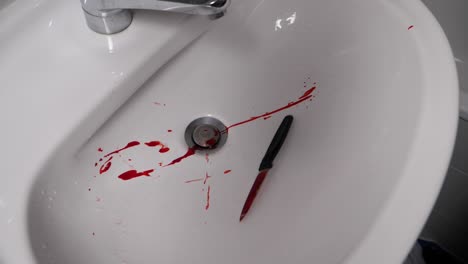 throwing homicide murder knife weapon in sink in slow motion