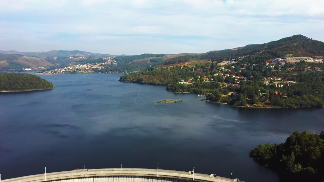 Car going through Dam in Northern Portugal, backwards drone aerial shot with river and forest