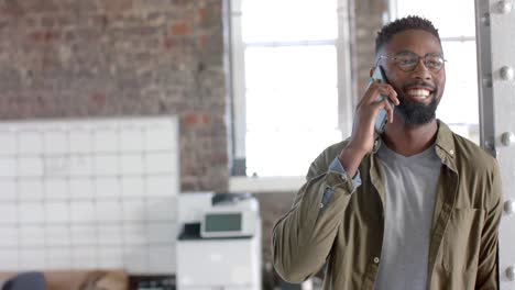 happy african american casual businessman talking on smartphone in slow motion