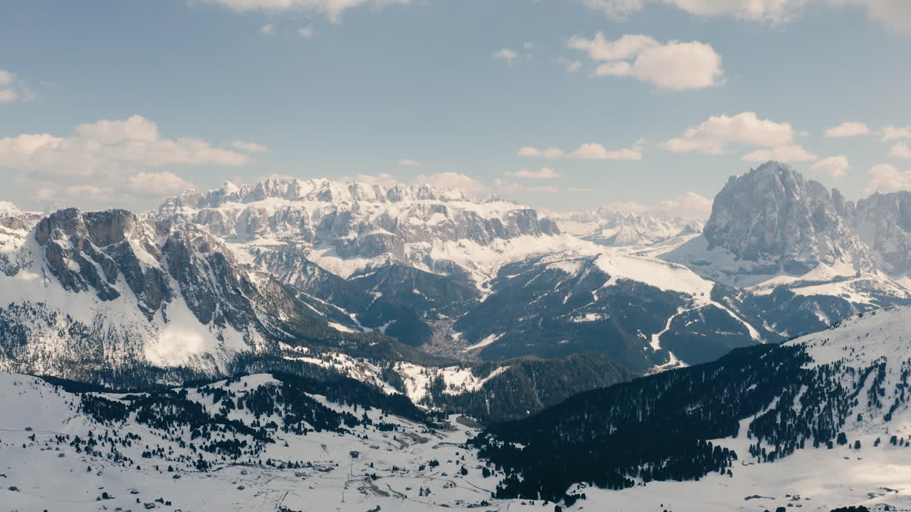 Dolomites panorama, sunlit high mountains and valleys aerial scenery