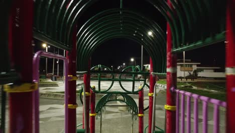 reverse shot of a kids playground at night