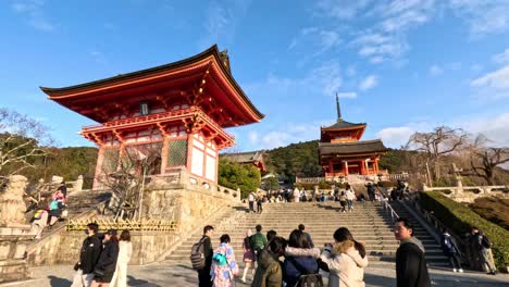 visitors ascend steps to a historic shrine gate