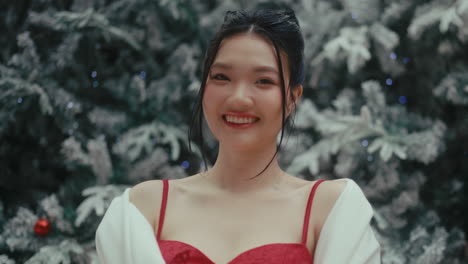 smiling woman by christmas tree
