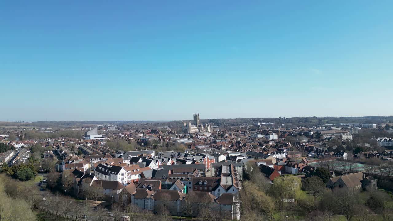 Canterbury Cathdral against a blue sky with city in the foreground drone shot