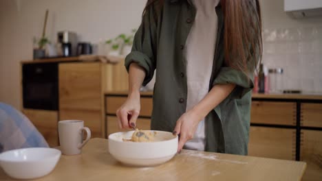 woman mixing dough in a kitchen