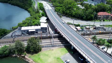 drone aerial pan landscape train on tracks train-line railway gosford station waterfront infrastructure travel transport brian mcgowan bridge central coast australia