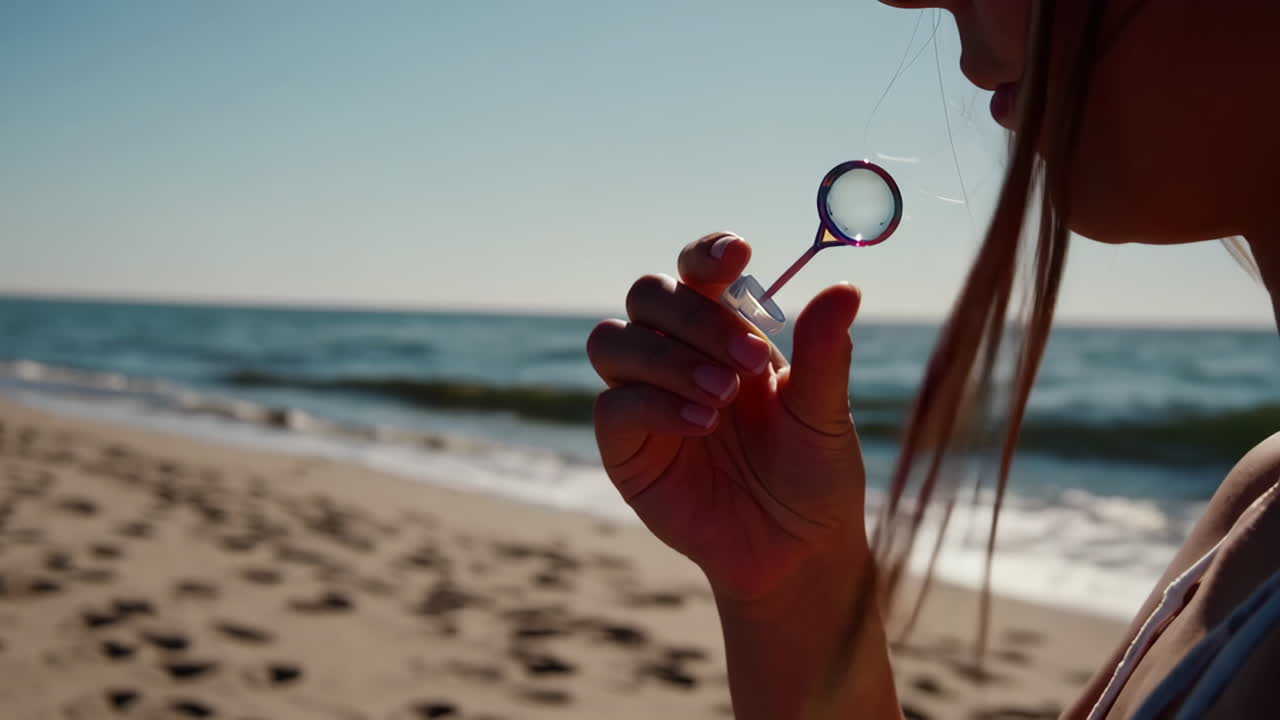 Person blowing bubbles on a sunny beach