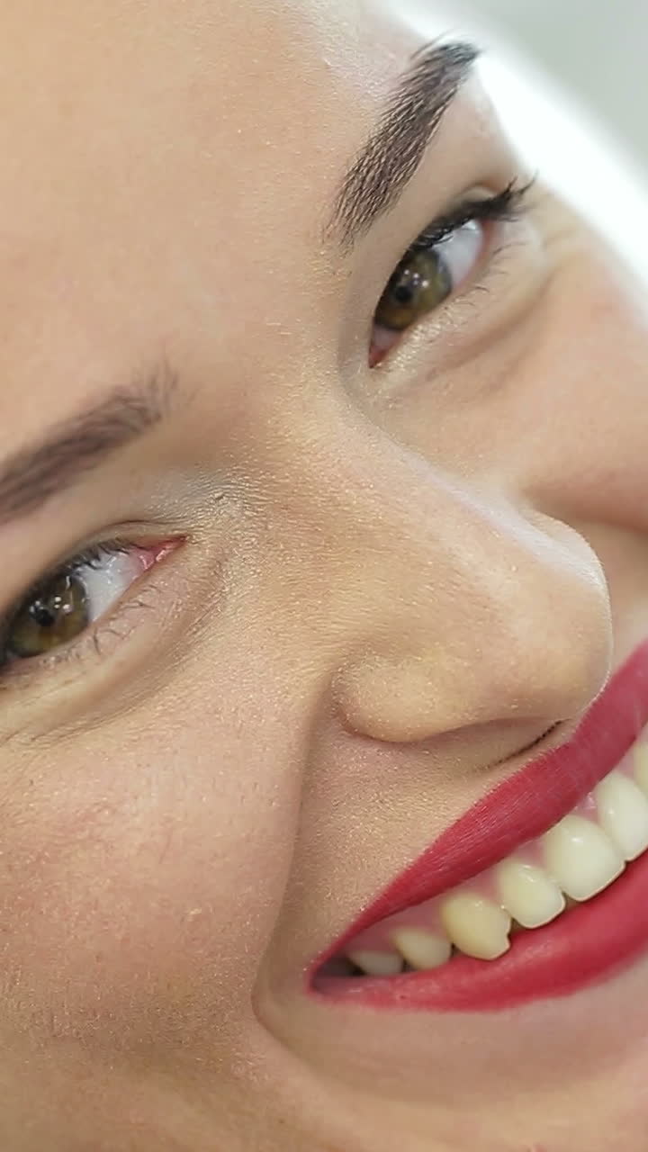 Girl Face With Makeup. Woman with permanent makeup looking at the camera