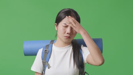 woman with headache and backpack