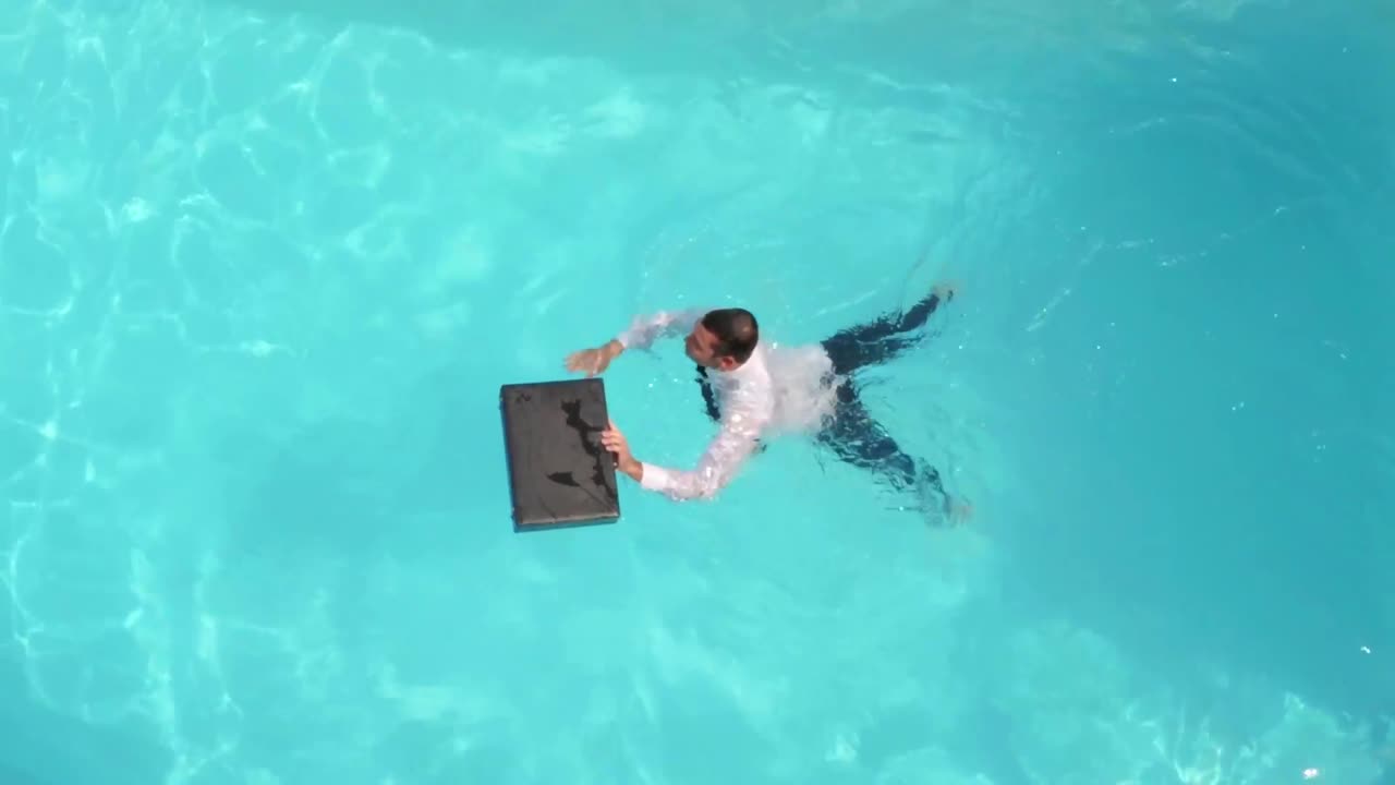 Businessman swimming in the pool