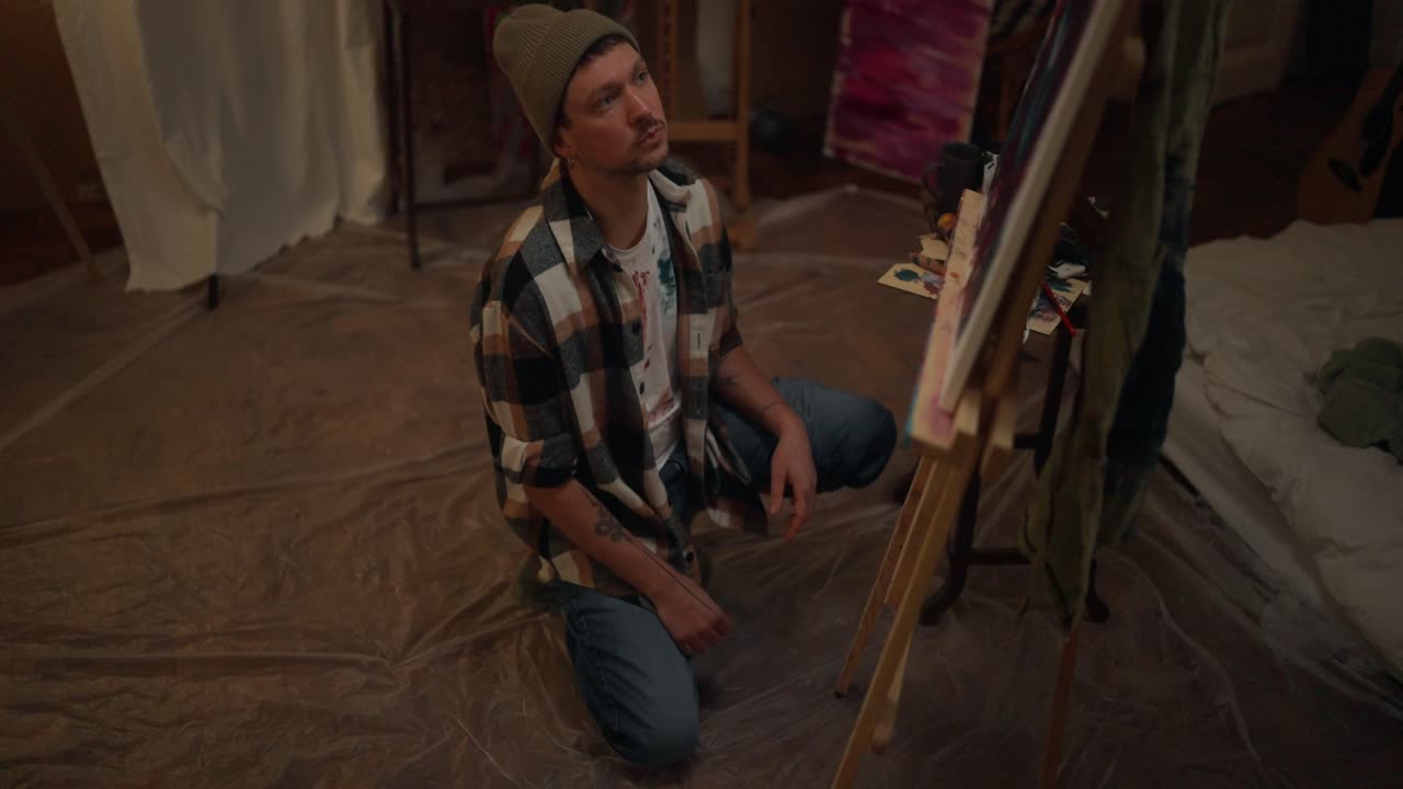 Artist Concentrating on Painting in Studio