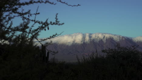 Time-lapse-of-the-Andes-mountain-range-on-a-beautiful-sunny-day-with-clouds-embracing-the-mountains