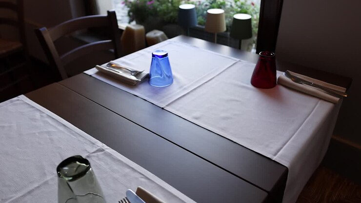 A table setup near a window in Cuneo, Italy