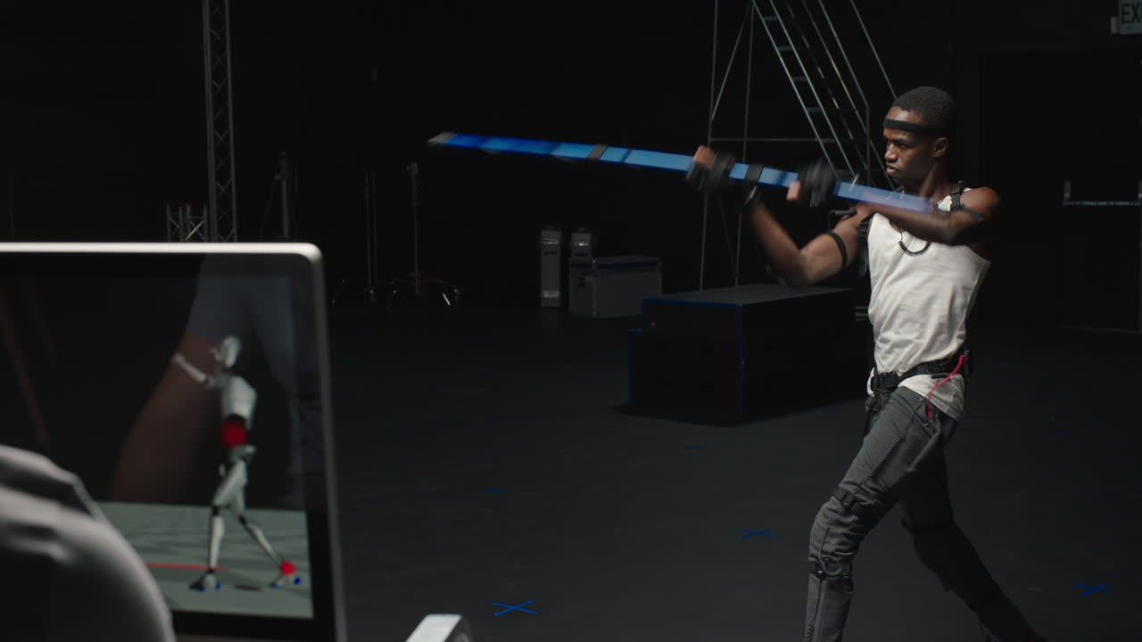 mocap man wearing motion capture suit in studio performing  bo staff sword fighting martial arts actor wearing mo-cap suit for 3d character animation for virtual reality gaming industry