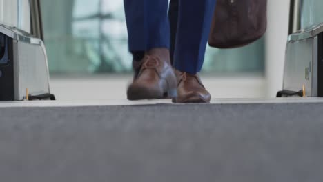 Business-people-on-an-escalator-in-a-modern-building