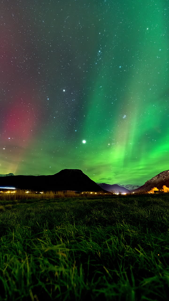 místico aurora boreal el lapso de tiempo en el cielo nocturno estrellado sobre las montañas, vertical