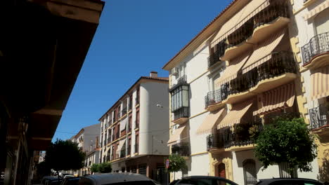 spanish street scene with colorful buildings and balconies