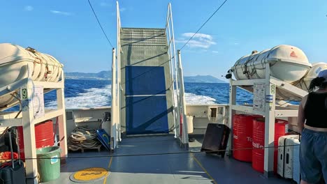 boat deck with ocean and lifeboats visible