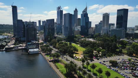 Aerial-view-backwards-movement-of-the-Perth-city-skyline-from-Elizabeth-Quay-during-a-sunny-day