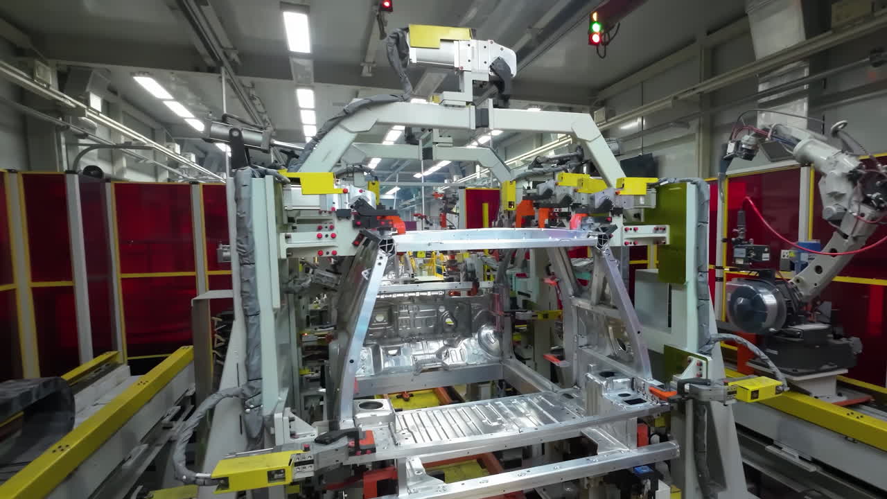 Robot arm inspecting an automobile assembly line works in a factory that assembles lithium or sodium batteries used in cars or electric vehicle