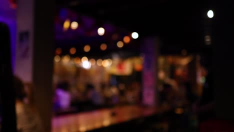 blurred bar setting with people and lights