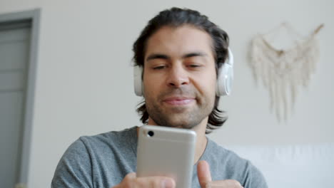 man listening to music and using phone