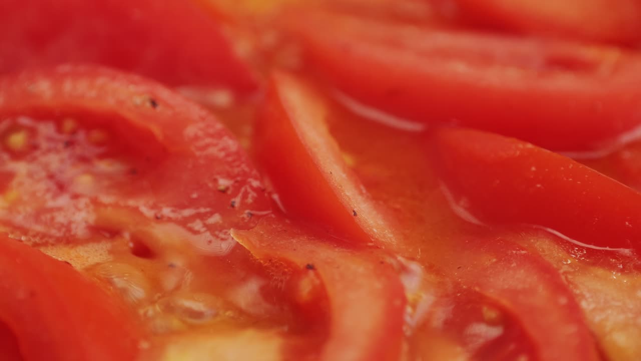 Cooking fresh peeled sliced tomato Juice sauce in pan, peeled tomatoes boiling in their own juice, making tomatoes pasta sauce .Top view close up, Italian traditional cuisine food.