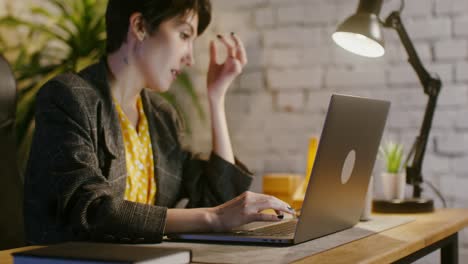 woman working on laptop at home office