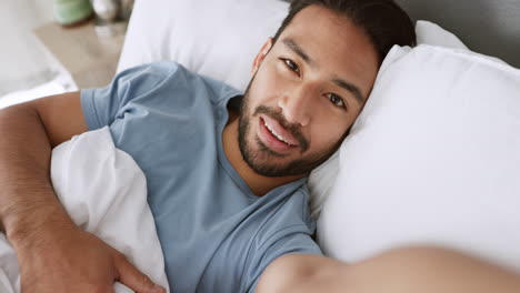 bed, phone and a man on a video call