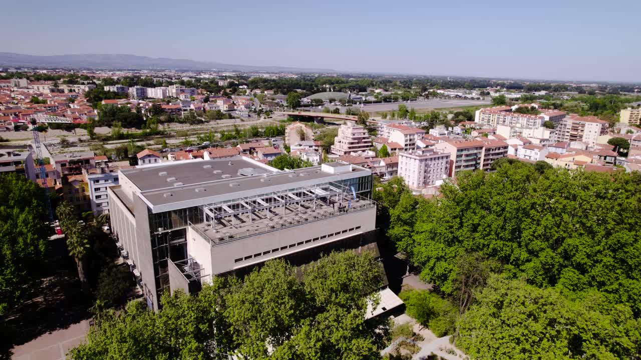 Majestic Trees and Modern Elegance: A Stunning Aerial Rotation of Perpignan's Palais des Congres in a Green Oasis