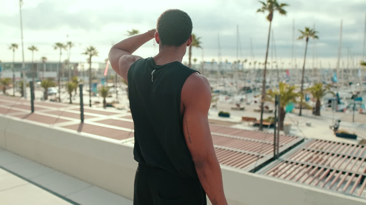 Athlete Takes a Break From Fitness at Harbor