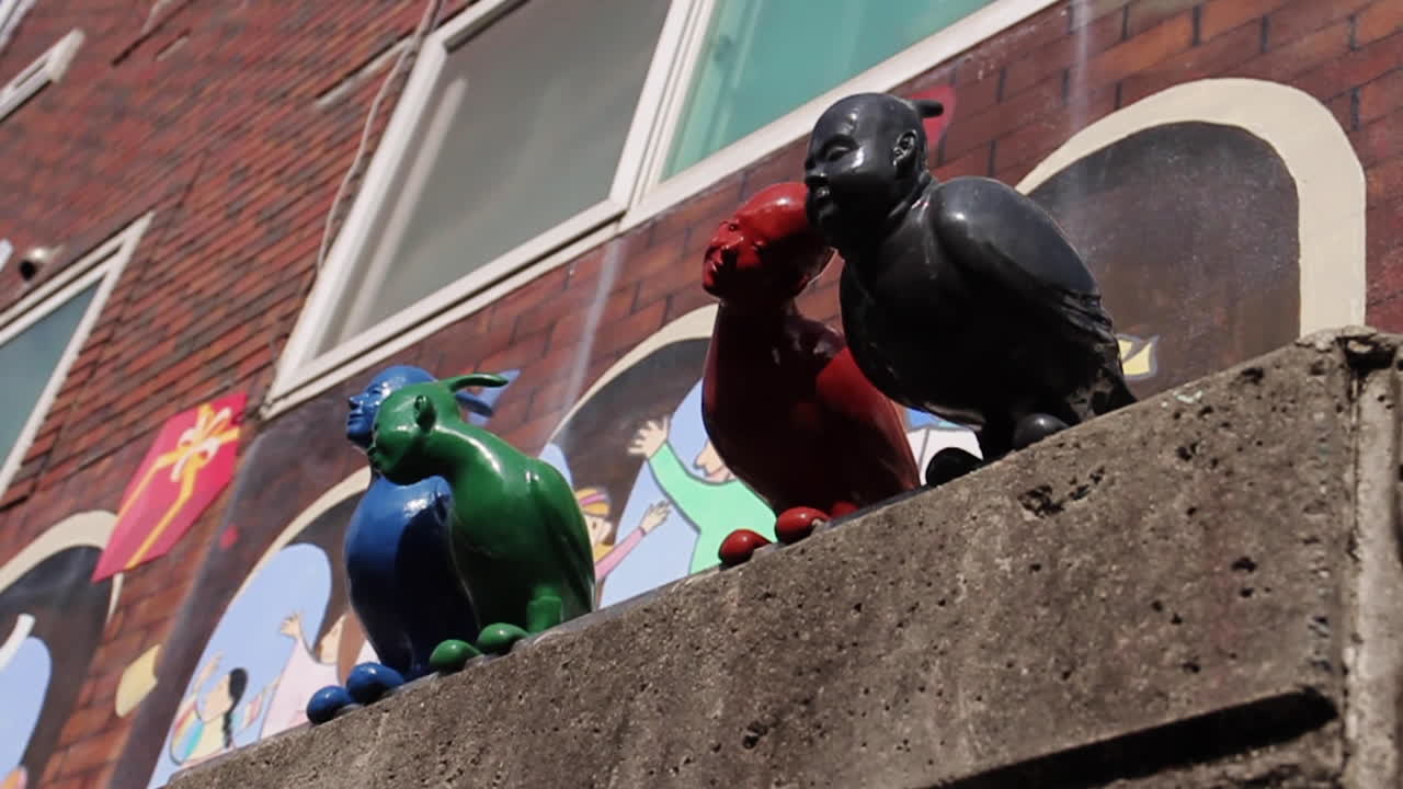 Colorful Statues on a Brick Wall