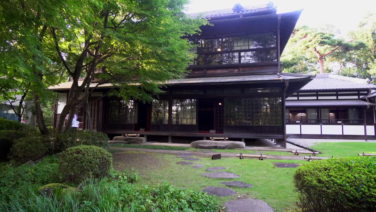 A man walks near a traditional house from the Edo Japanese period (1603-1868) in Tokyo. The influence of the busimo zen in its architecture and garden design is very clear.
