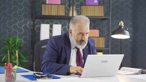 Stressed-businessman-using-laptop.