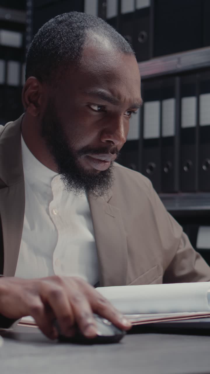 Vertical video: Male inspector reading witness statements and clues