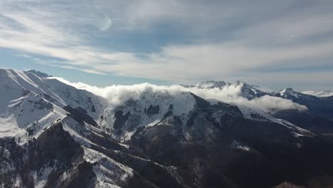 aerial time lapse of clouds disappearing on snowy mountains. sunny day in france