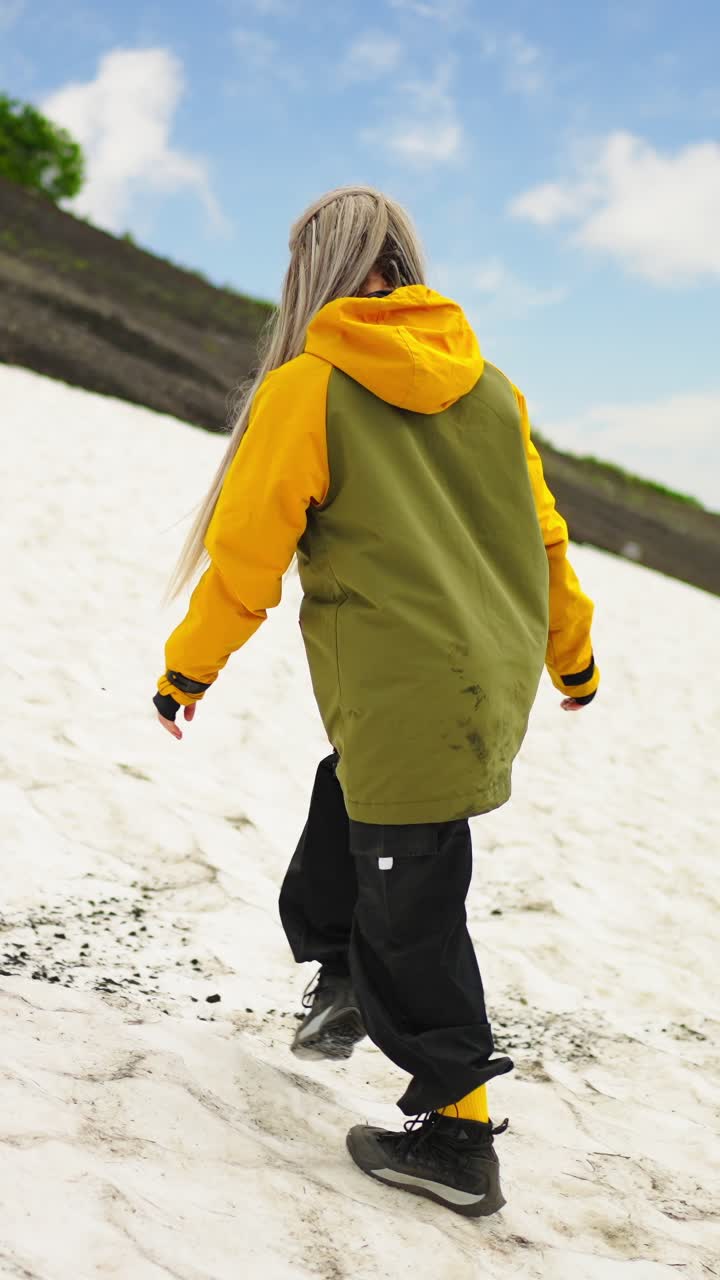 Young Woman Hiking Up a Snowy Mountain Slope