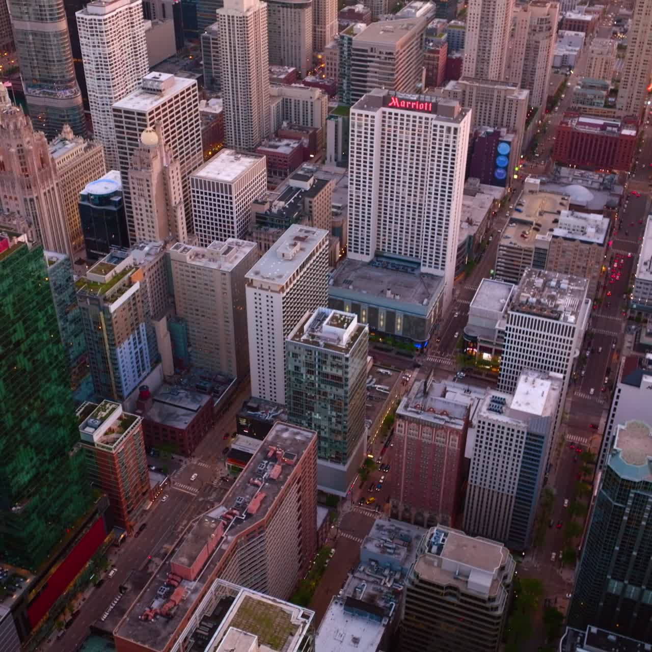 Modern beautiful high buildings of Chicago downtown. Vibrant city lighting lights in the evening. Top view