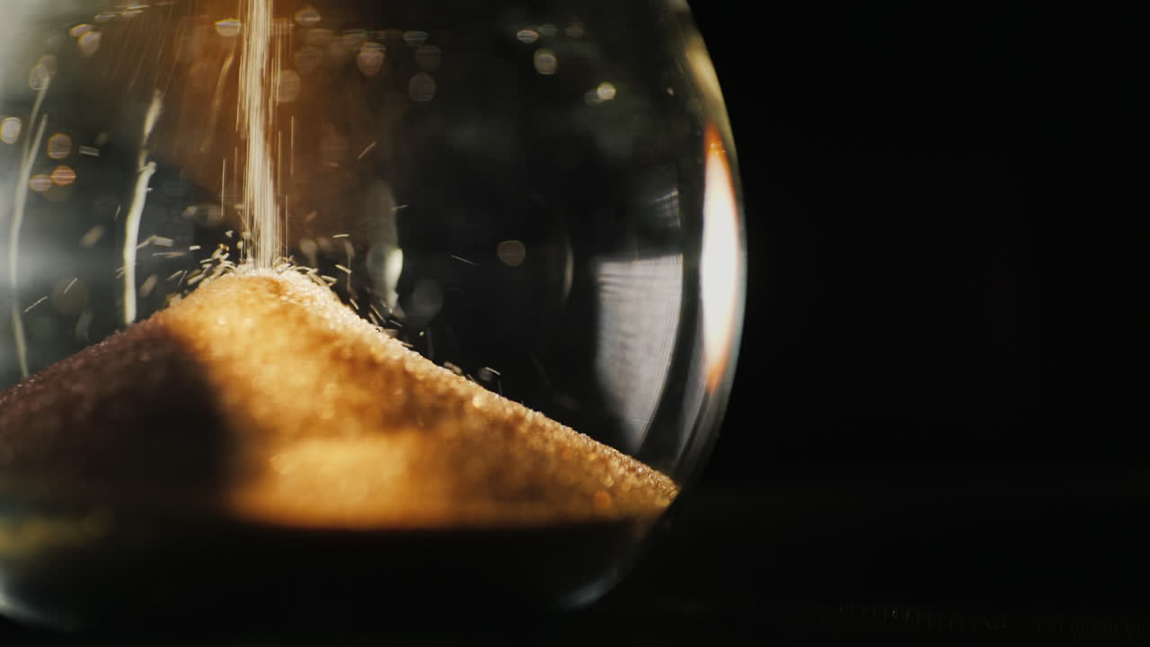 The lower part of the hourglass the little grains of sand fall from above