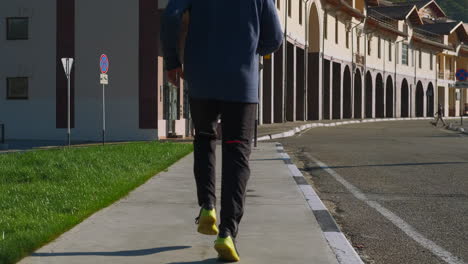 man running on city sidewalk