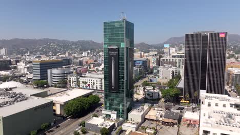 Sunset-Vine-Tower-Apartments-in-Hollywood,-orbit-aerial-during-the-day