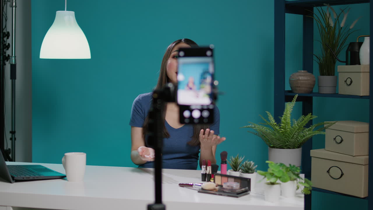 Asian woman filming makeup tutorial with smartphone camera