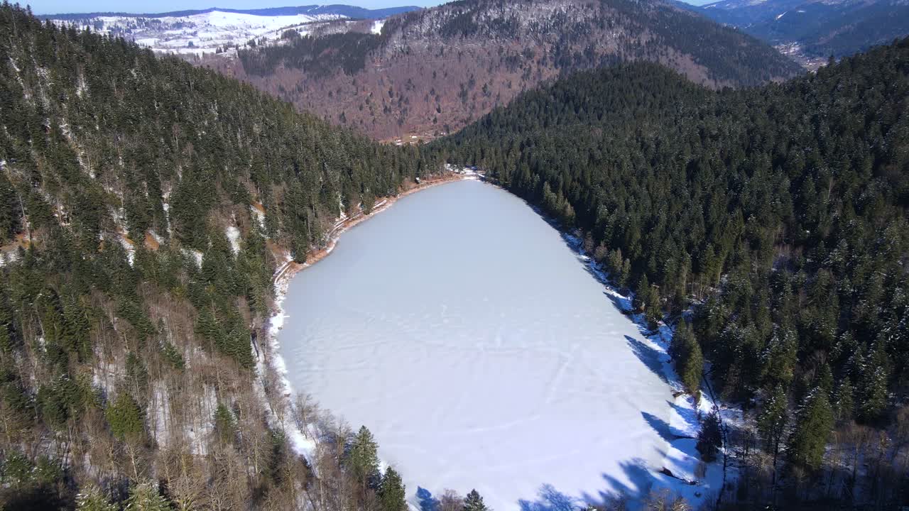 Frozen lake Corbeaux nature in winter La Bresse France aerial drone nature forest