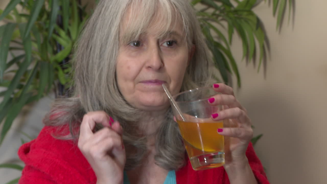 Elderly Woman Drinking Liquid