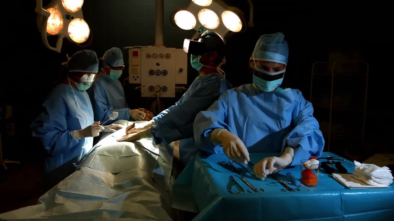 Surgeons performing operation in operation room