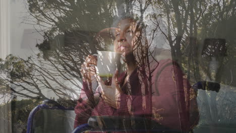 holding cup, elderly person with forest trees visible in background